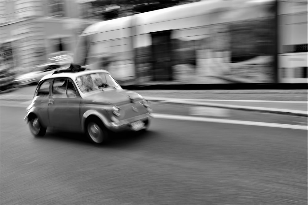 grayscale photo of car on road