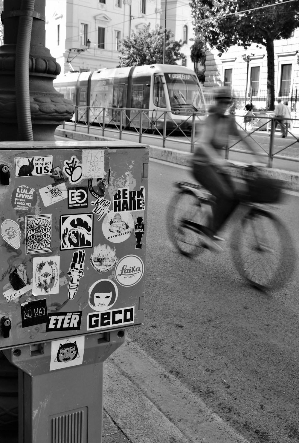 man in black jacket riding bicycle with white and black sticker