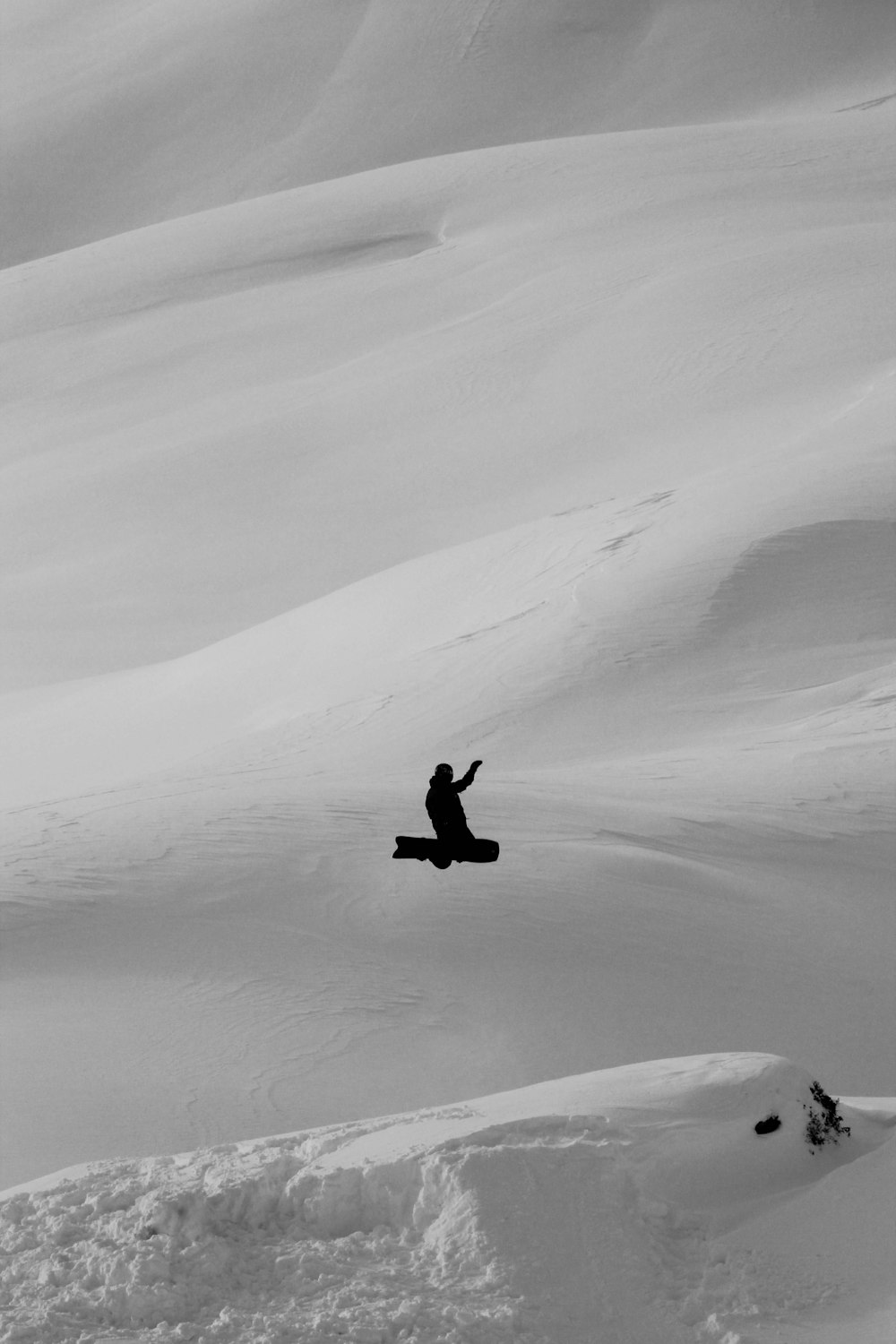 person in black jacket walking on snow covered field during daytime