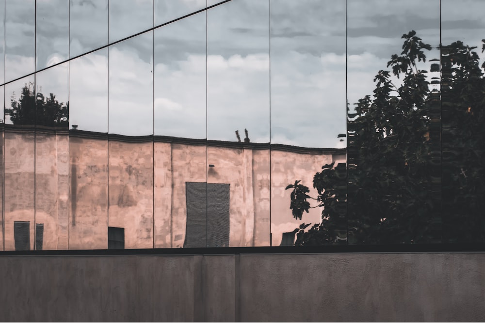 brown concrete building near green trees during daytime