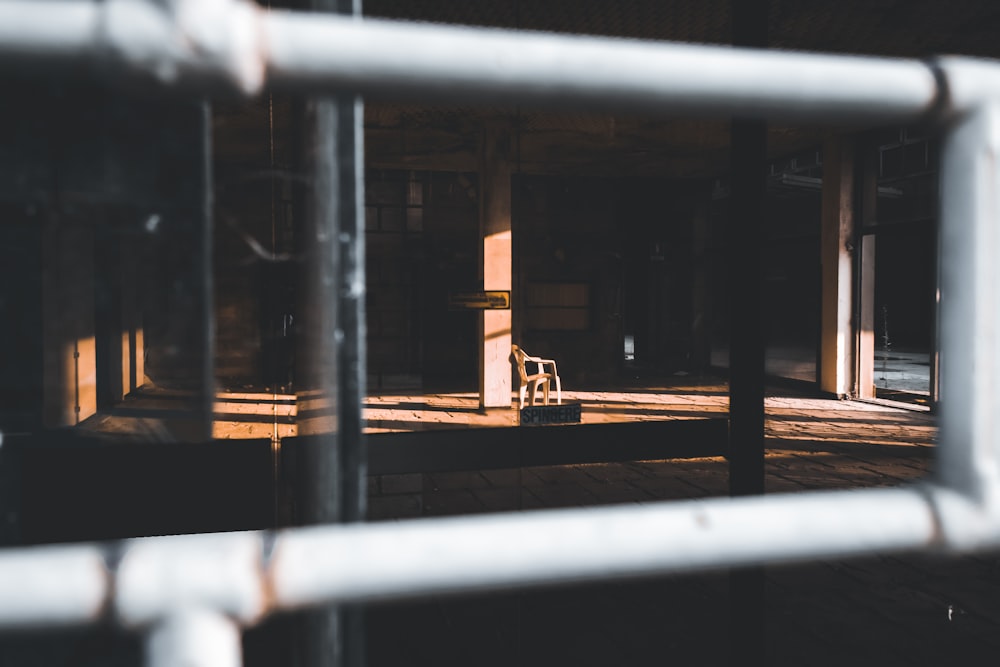 white metal fence near brown wooden bench