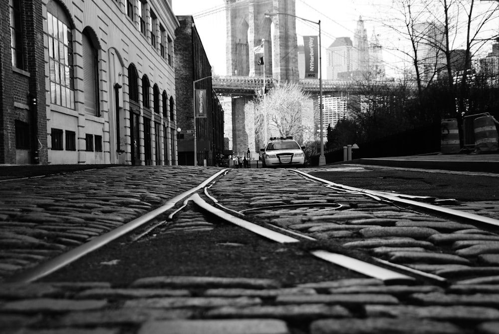 grayscale photo of a road in the middle of a city