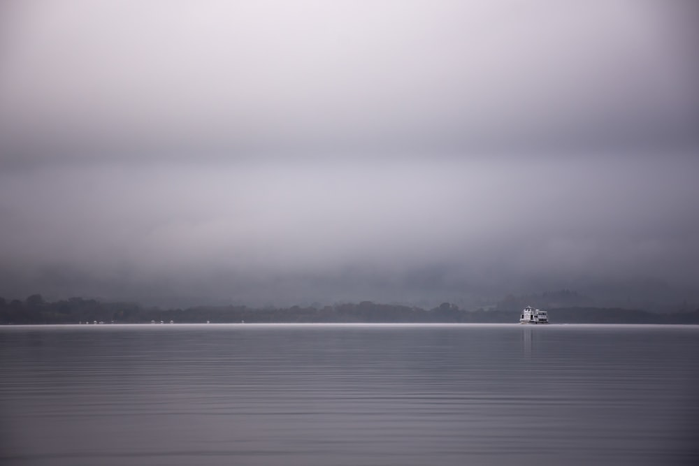 grayscale photo of boat on sea