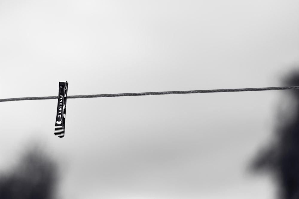 black cross pendant on white wall