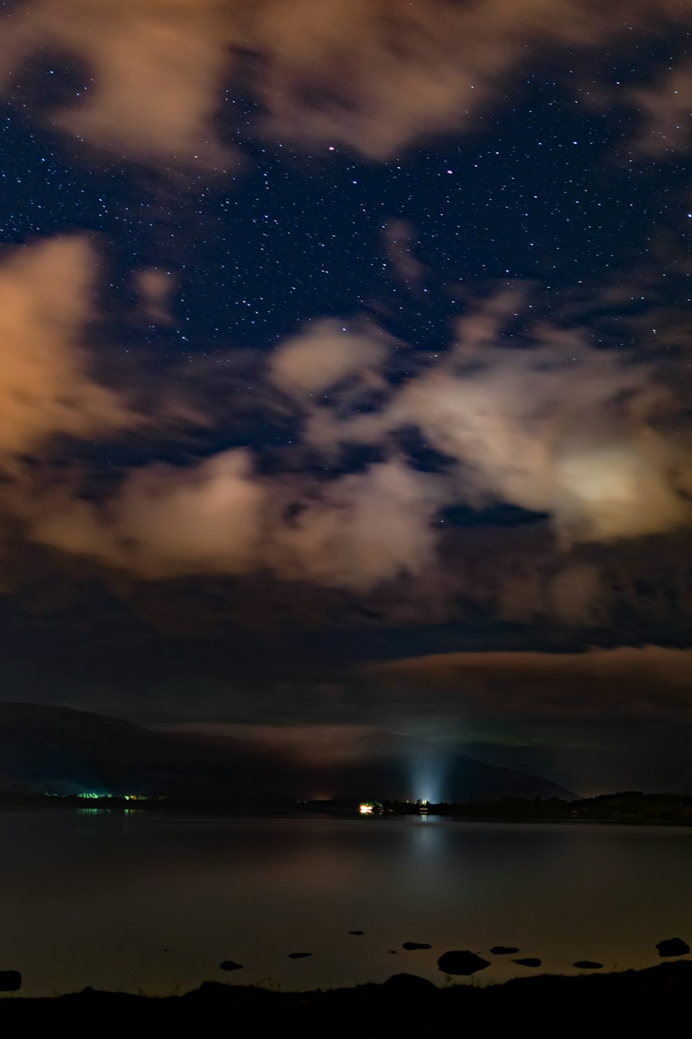 body of water under black sky