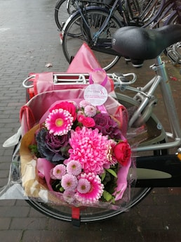 A delivery bike with a basket full of colorful flowers on a Berlin street.
