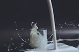white candle in clear glass holder