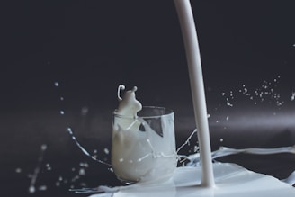 white candle in clear glass holder