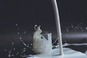 white candle in clear glass holder