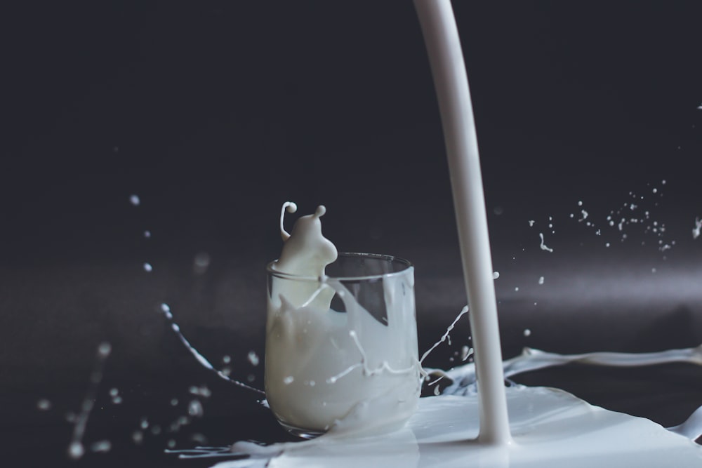 pouring milk into a glass. 