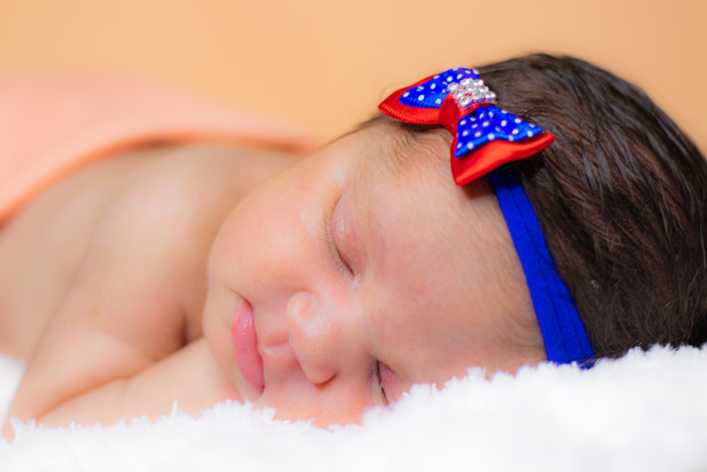 baby in blue and white polka dot headband