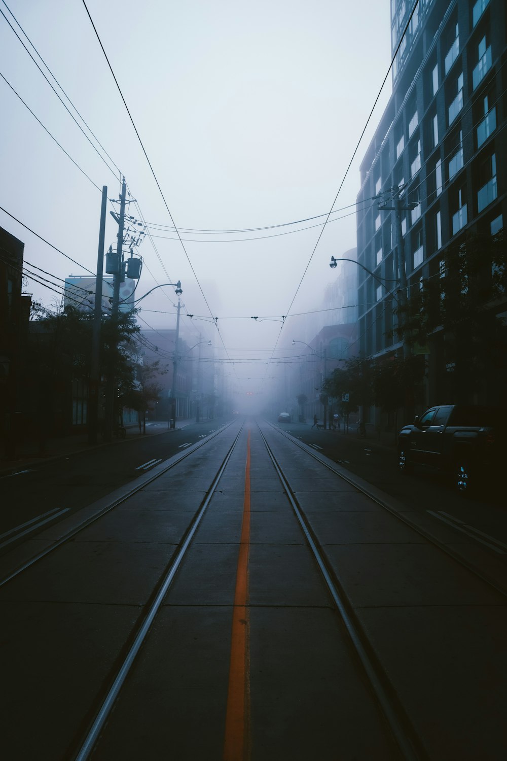 cars on road between buildings during daytime