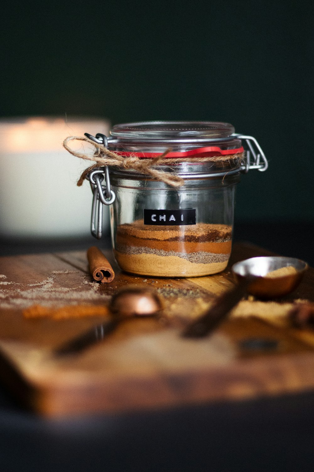 clear glass jar with brown powder on brown wooden table