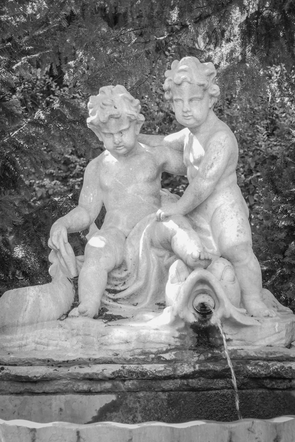 grayscale photo of 2 topless women statue