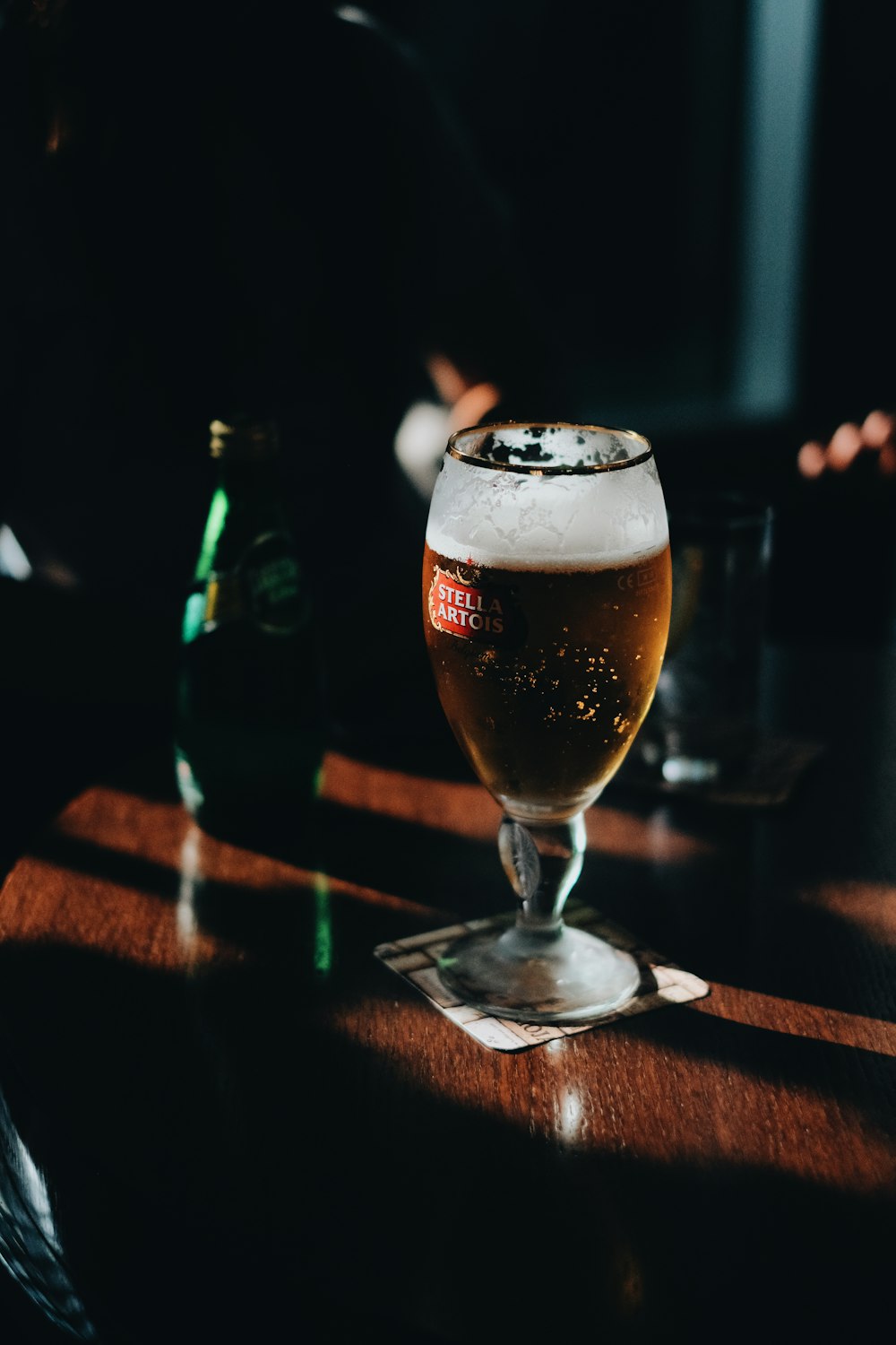 clear drinking glass with brown liquid