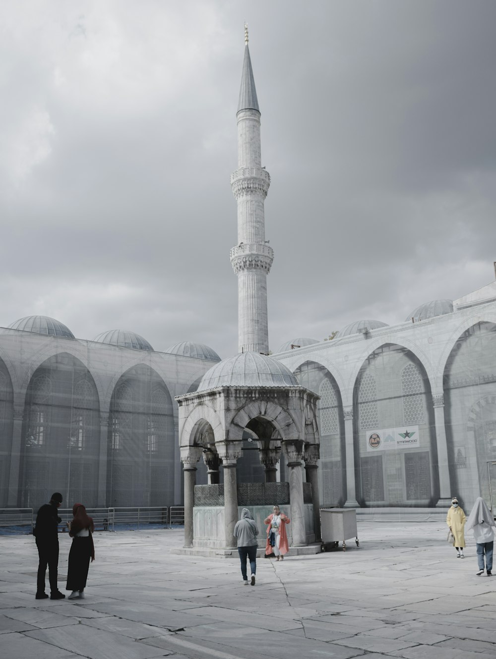 people walking near white concrete building during daytime