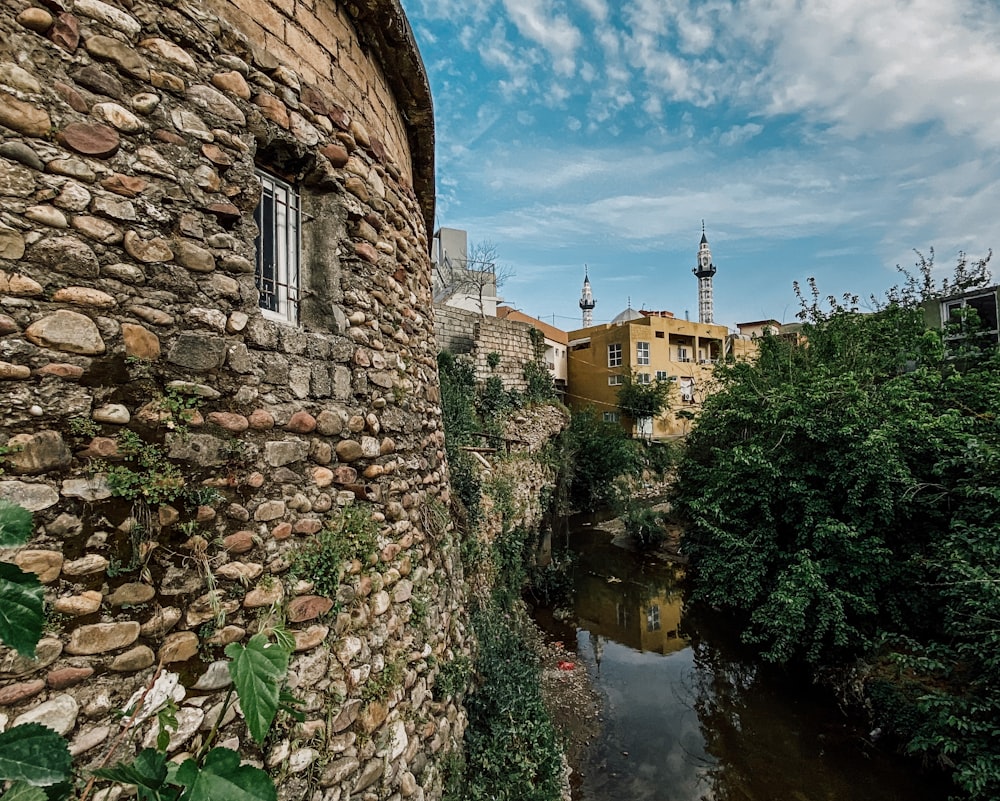 brown brick building near river