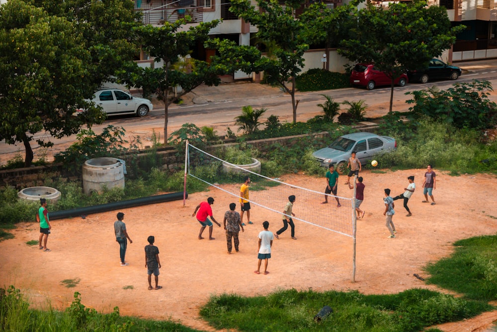 people playing basketball on court during daytime