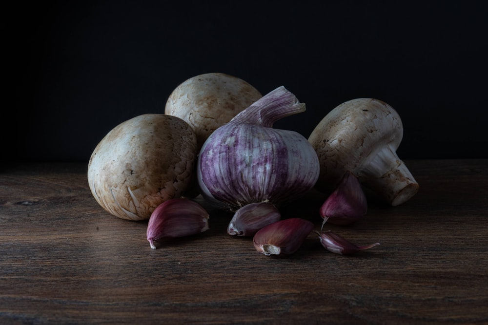 white garlic on brown wooden table