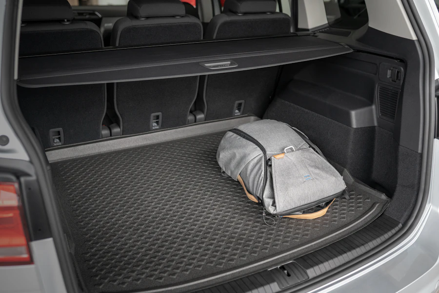 Trunk organizer bag secured in the back seat of a car