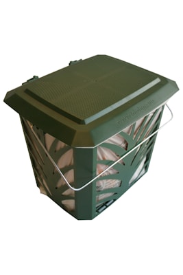 A green, perforated compost bin with a metallic handle. The lid appears secure, and part of the bag inside is visible through the openings in the container.