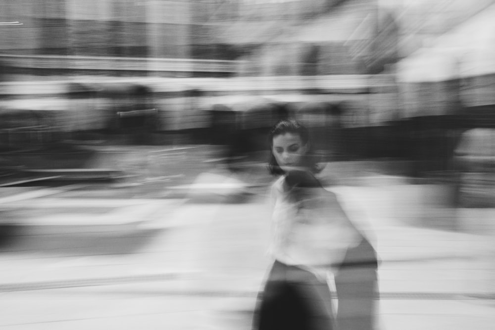 a blurry photo of a woman walking down the street
