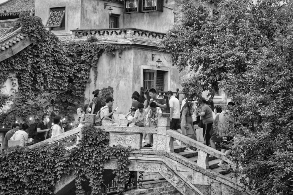 grayscale photo of people walking on stairs