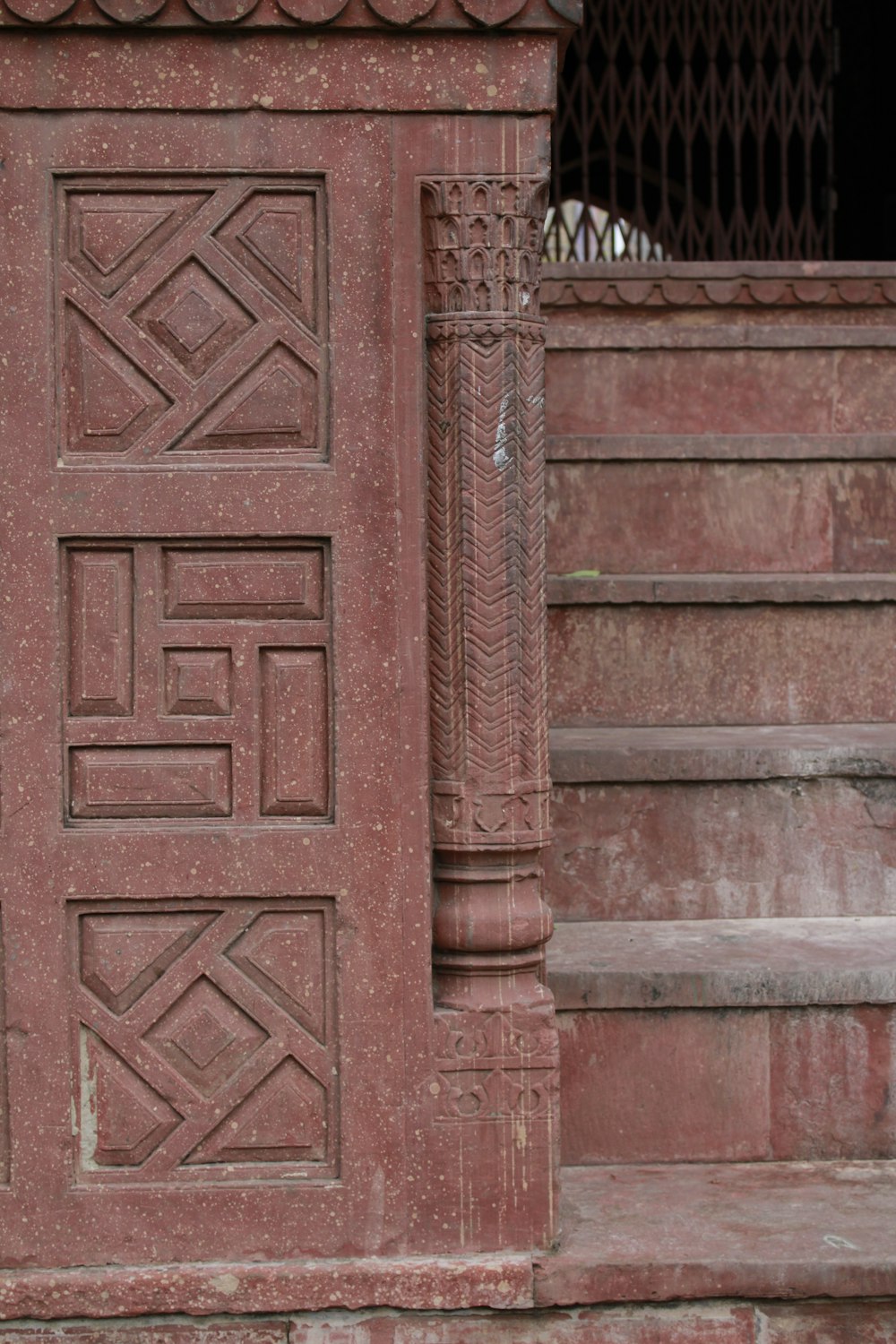 brown wooden door on gray concrete staircase