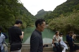 A group of participants engaging in a nature photography session by a serene lake.