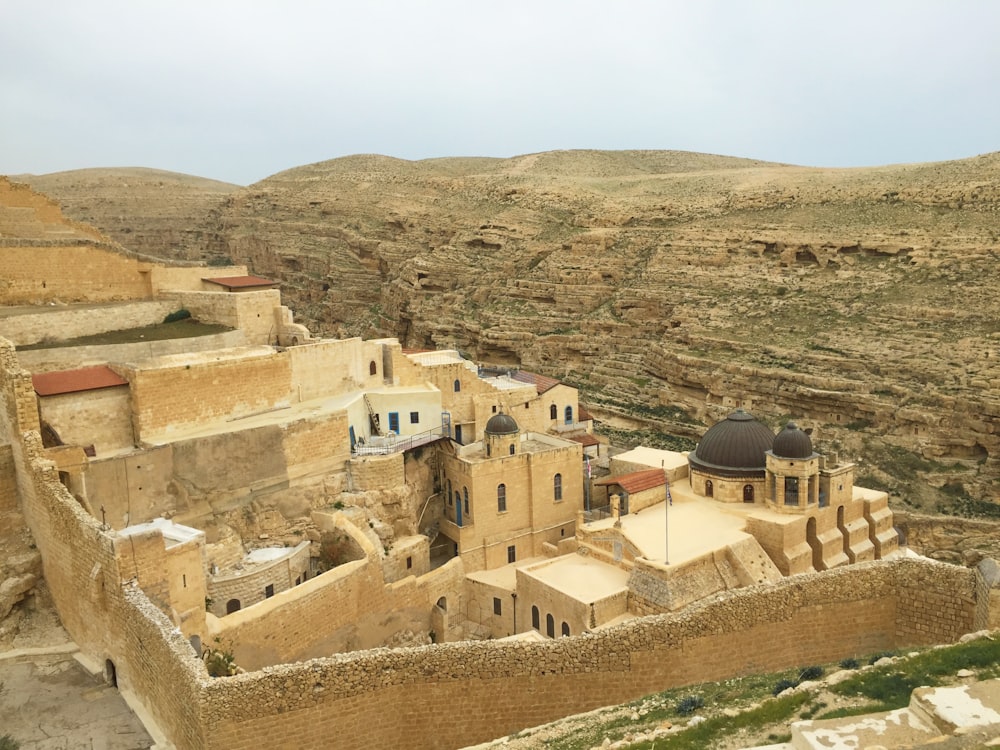 brown concrete houses on hill during daytime