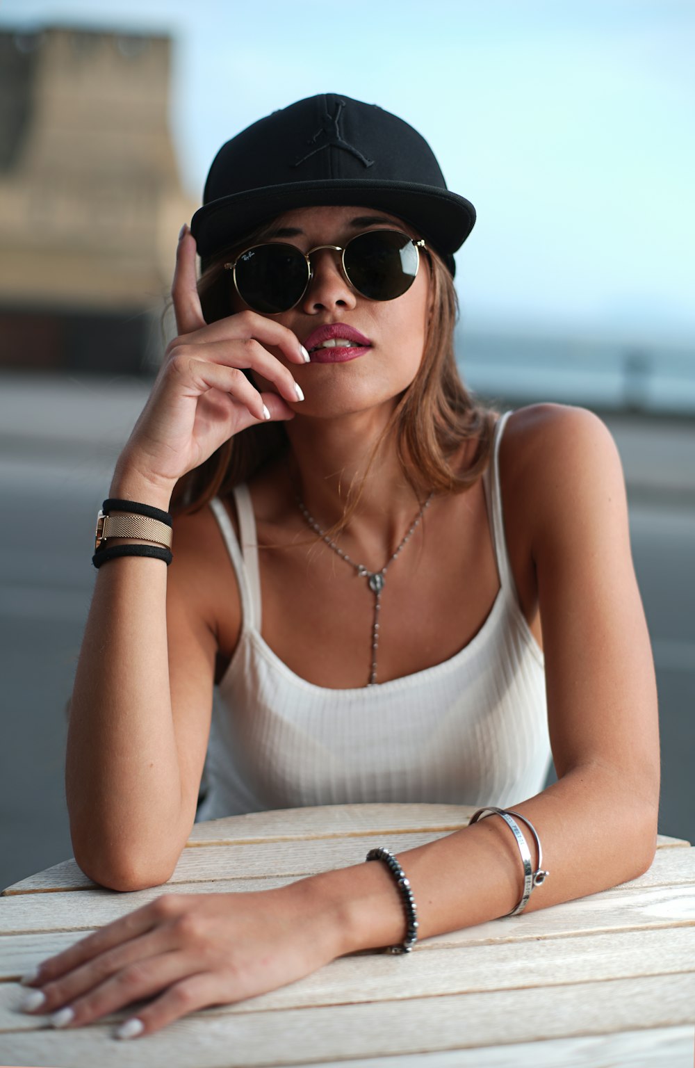 woman in white tank top wearing black sunglasses