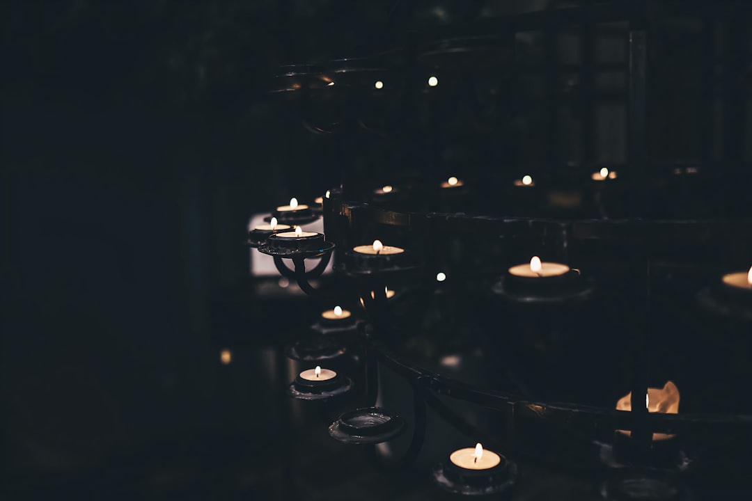 lighted candles on black metal rack