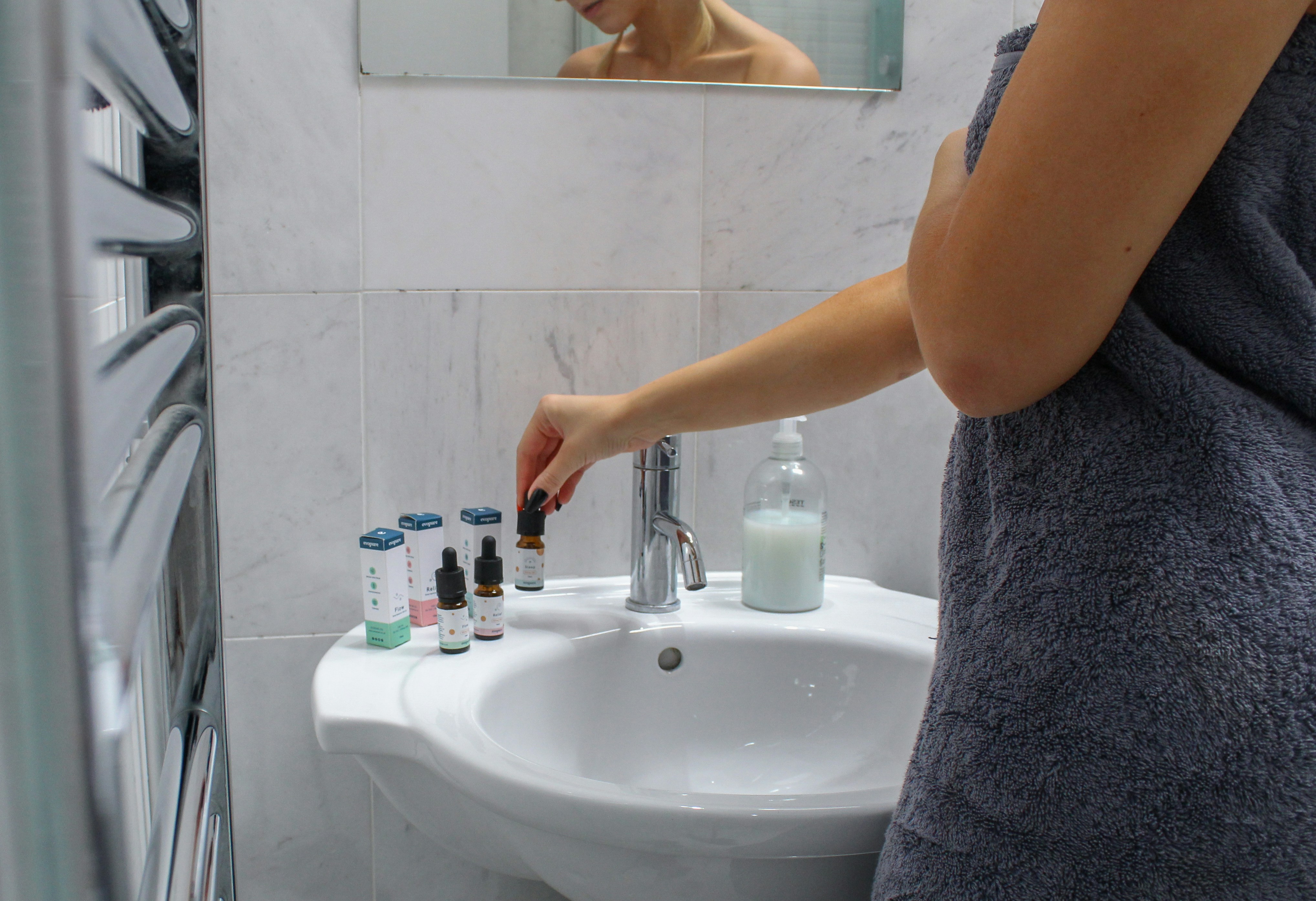 person holding white ceramic sink
