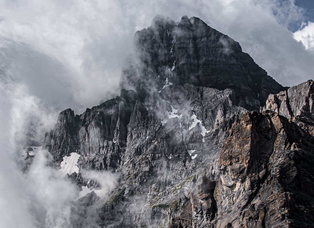 gray rocky mountain with fog