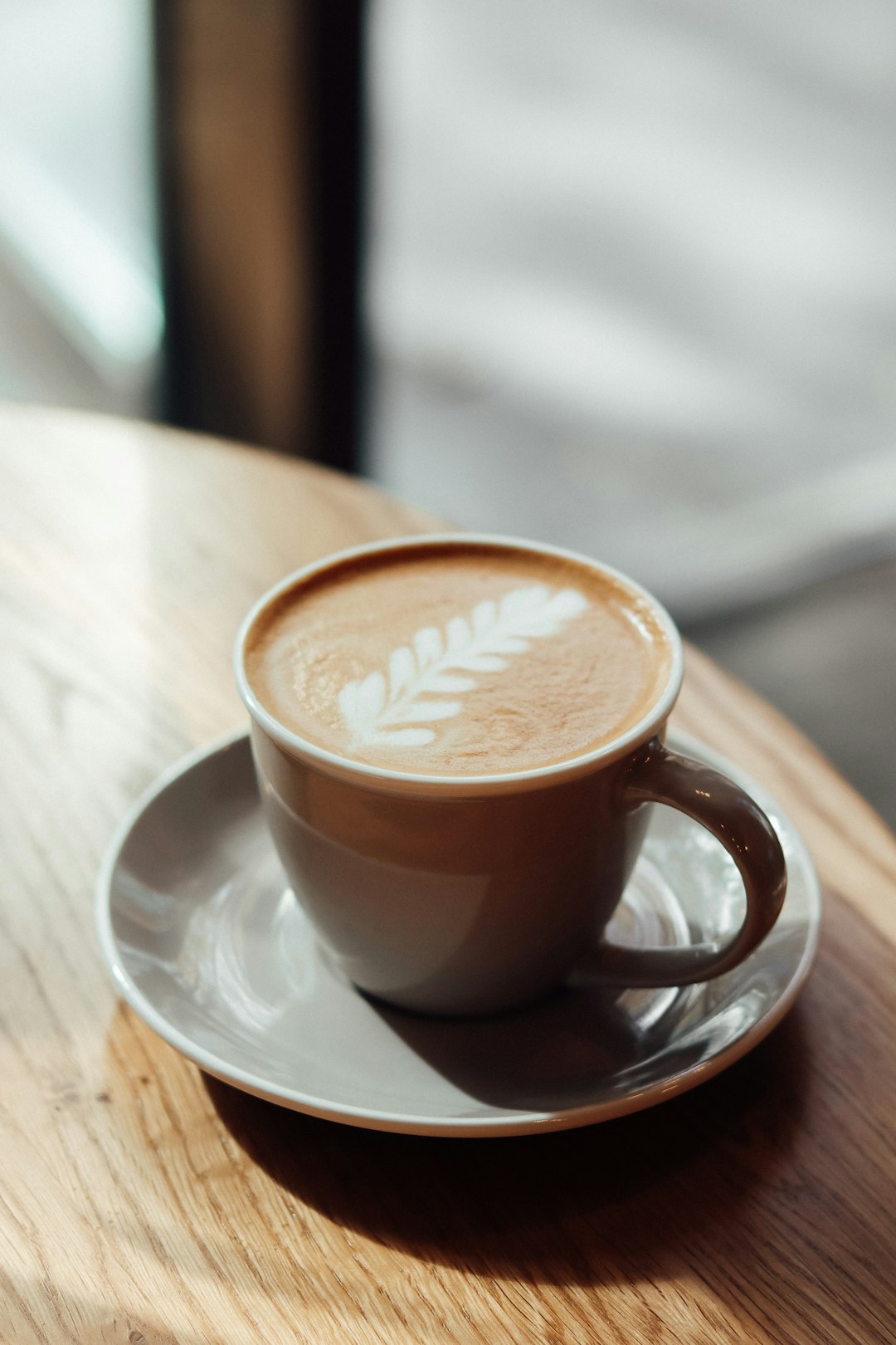 brown ceramic mug on white ceramic saucer