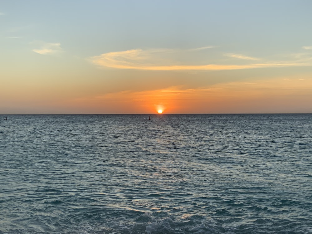 body of water during sunset