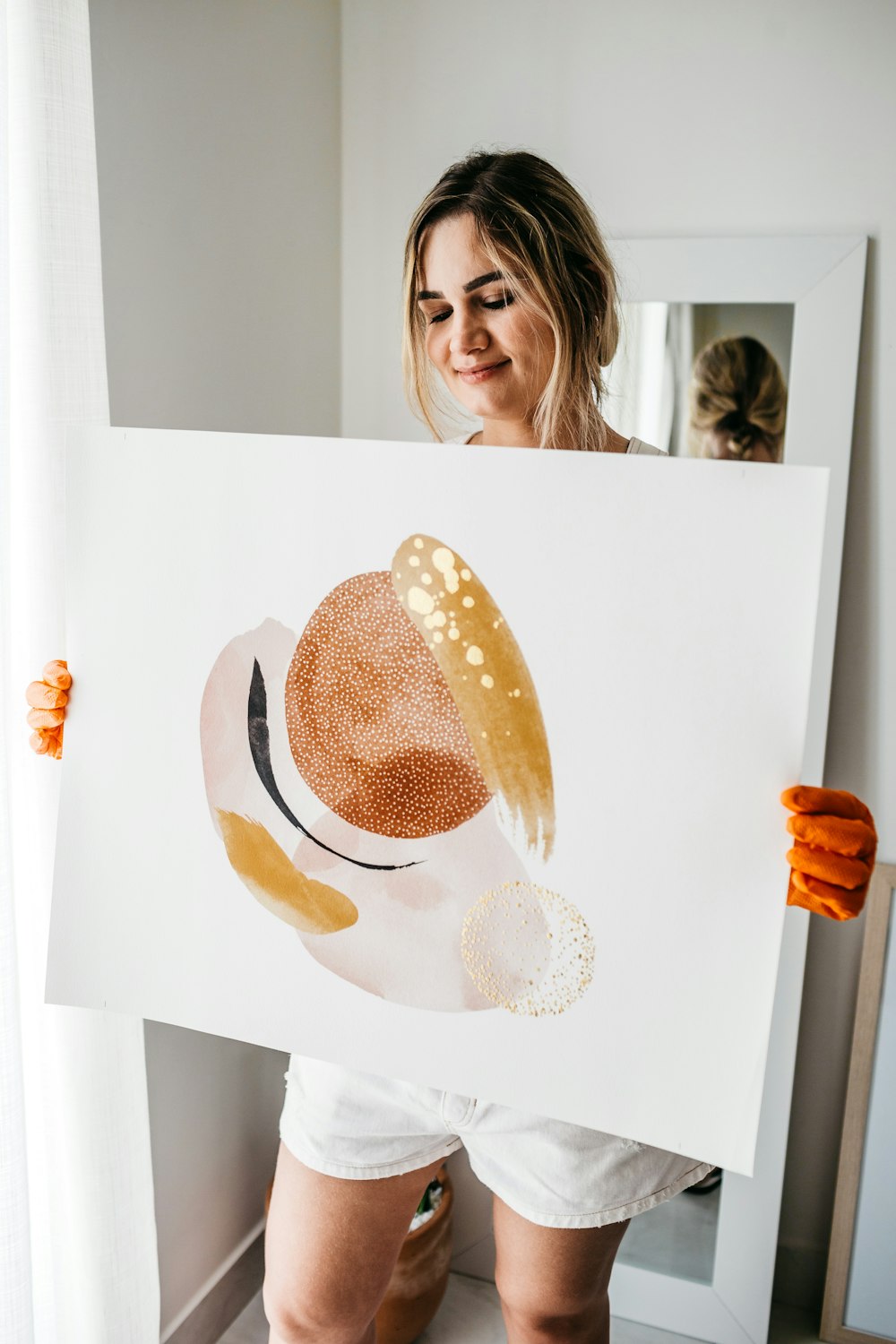 woman holding white and brown polka dot paper