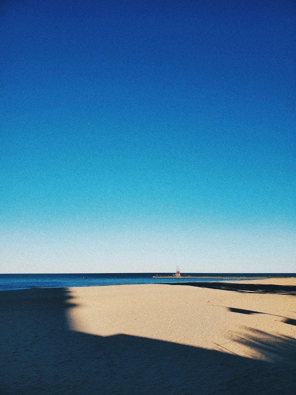 person walking on beach during daytime