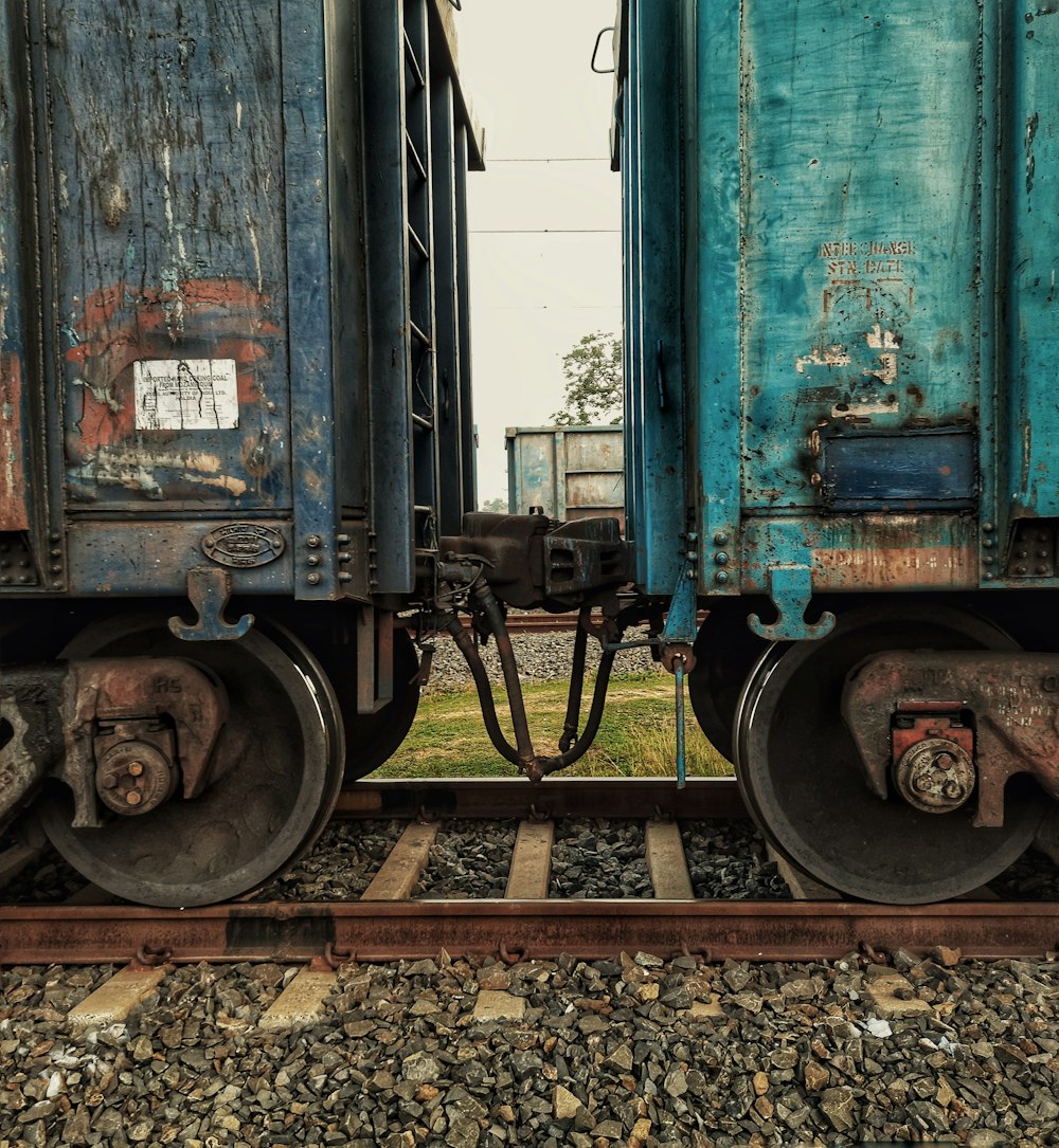 blue train on rail tracks during daytime