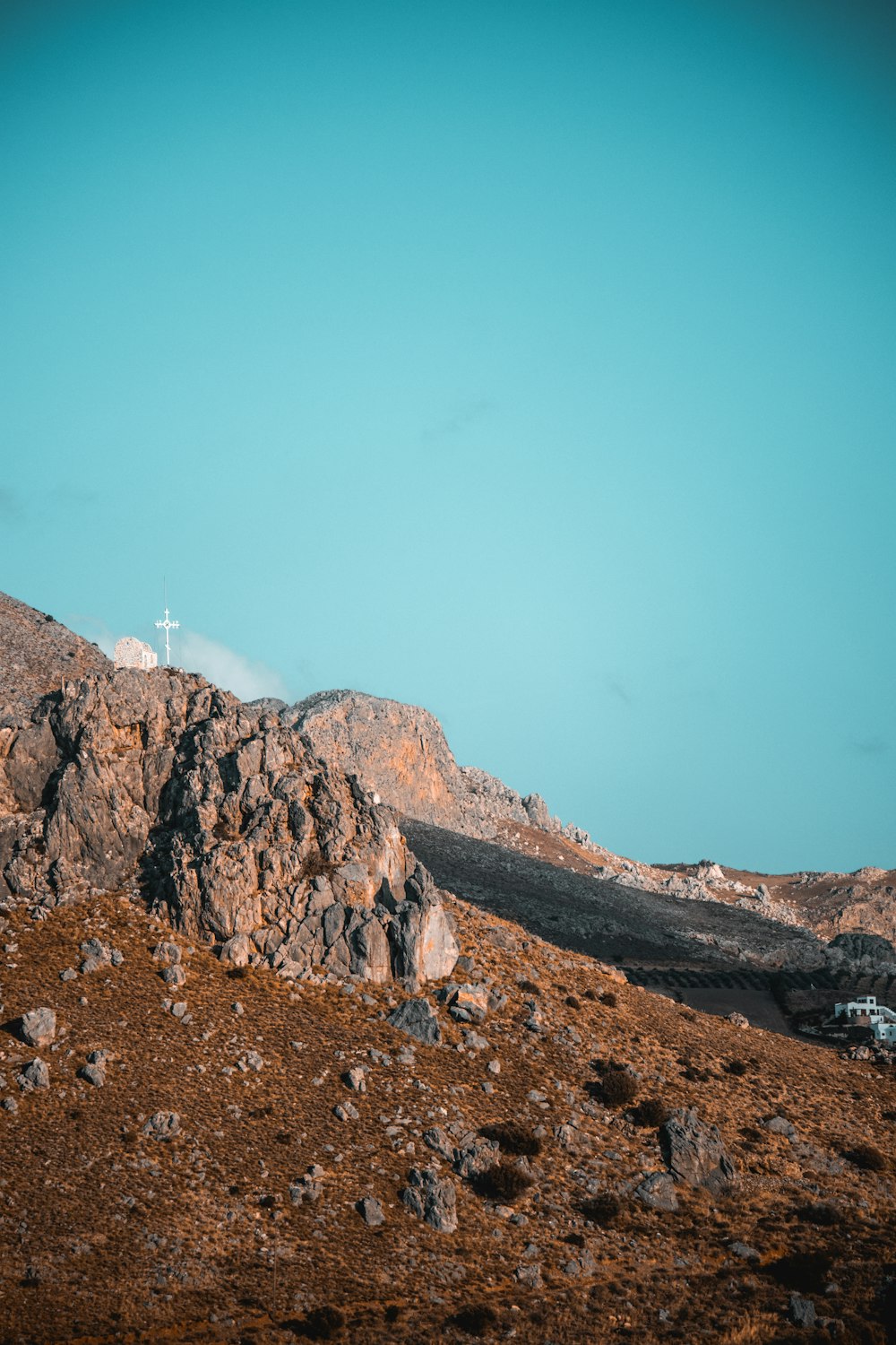 brown rocky mountain under blue sky during daytime