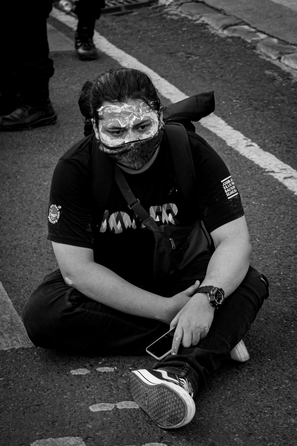 man in black t-shirt and black helmet sitting on road