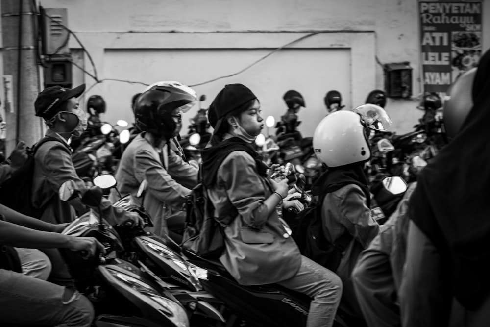 grayscale photo of people riding motorcycle