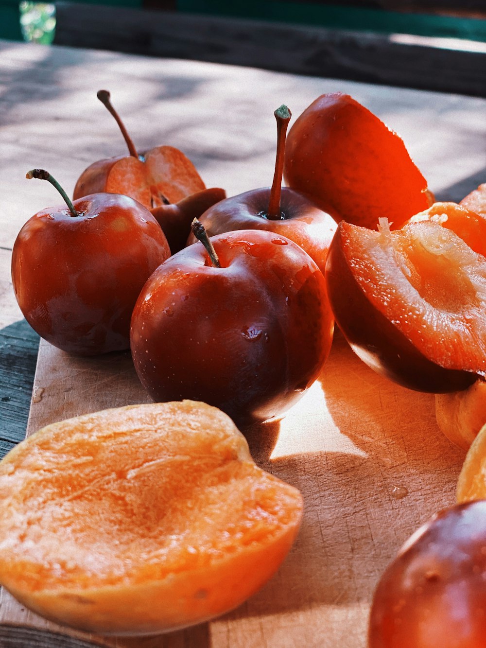 red apple fruit on brown wooden chopping board