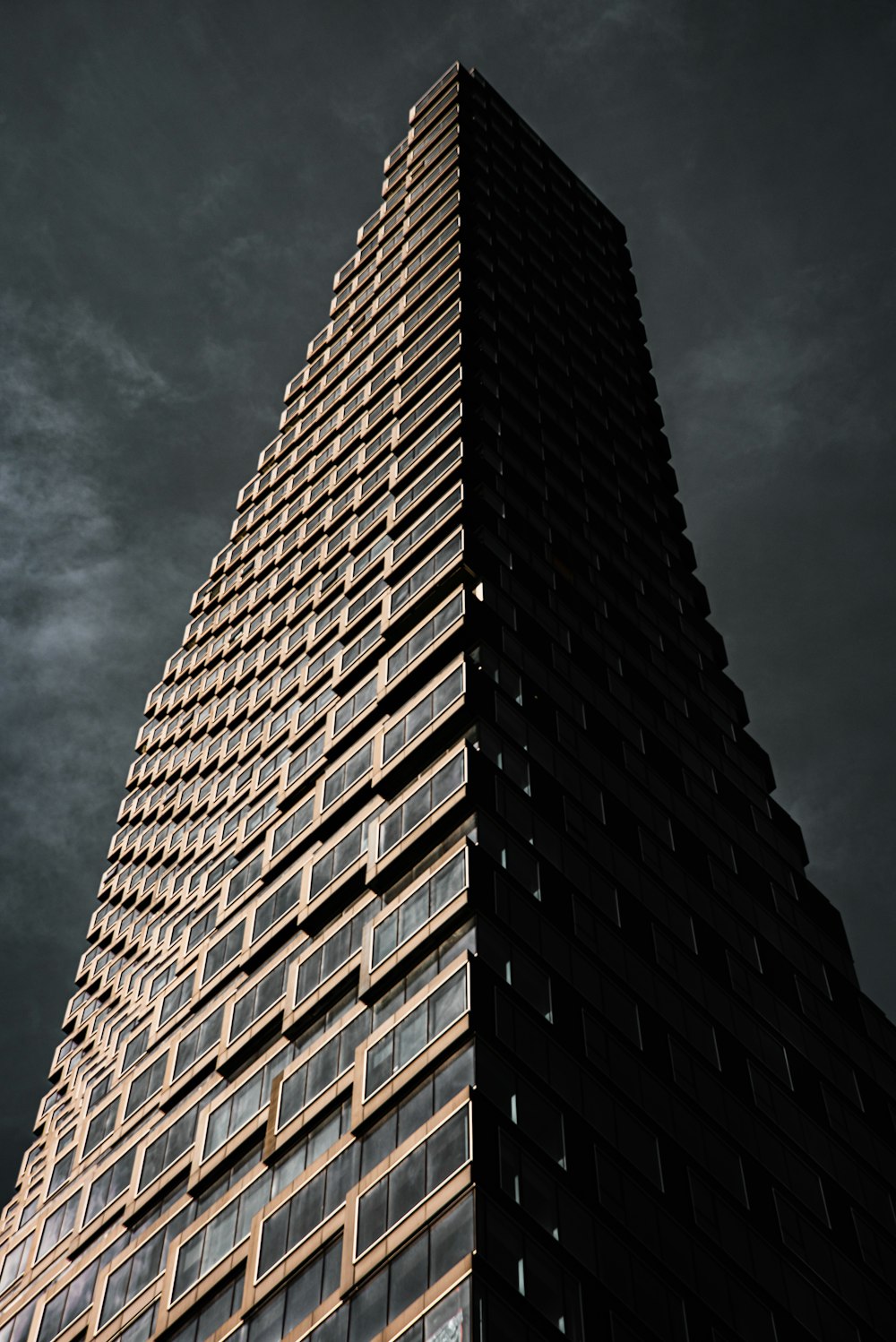 brown concrete building under cloudy sky during daytime