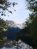 A serene landscape of a mountain reflecting in a calm lake.