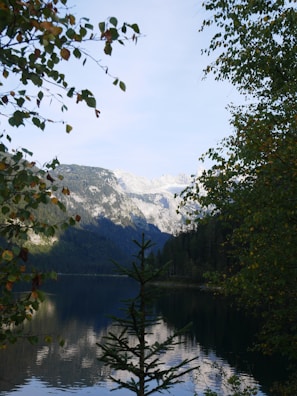 A serene landscape of a mountain reflecting in a calm lake.