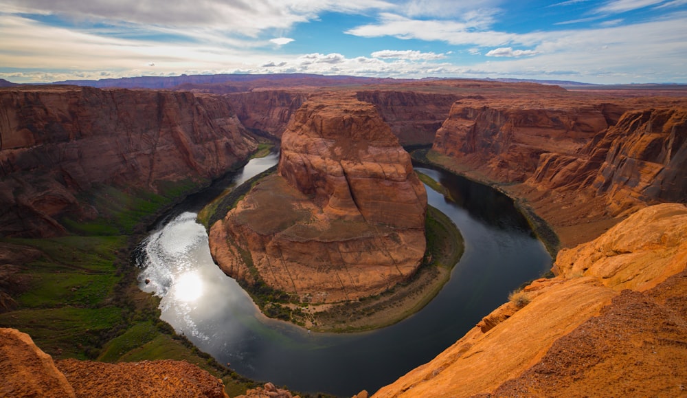 brown rock formation near river during daytime