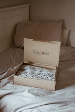 brown cardboard box on white and black floral textile