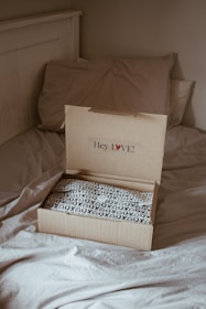 brown cardboard box on white and black floral textile