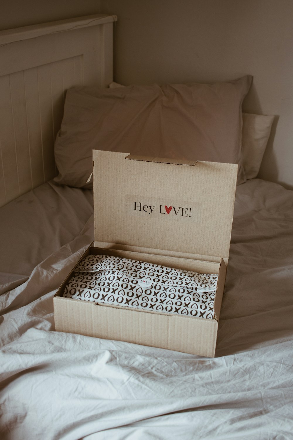 brown cardboard box on white and black floral textile